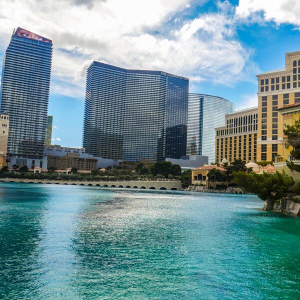 Aria's curved glass tower rising beyond the Bellagio lake on the Las Vegas Strip