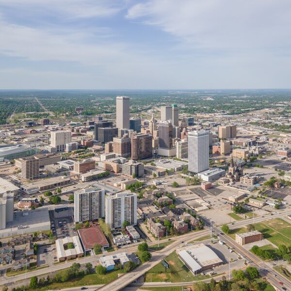 Aerial view of downtown Tulsa skyline with high-rise towers and surrounding streets