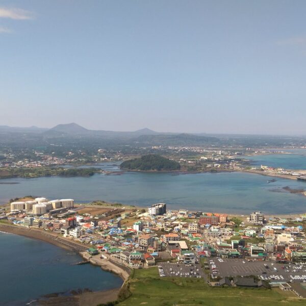 Coastal town of Seongsan on Jeju Island, with bay, bridge and distant volcanic hills
