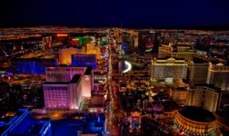 Aerial night view of the Las Vegas Strip lined with brightly lit casino resorts