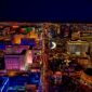 Aerial night view of the Las Vegas Strip lined with brightly lit casino resorts