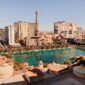 Bellagio fountain lake with Paris Las Vegas and Strip resorts under clear sky