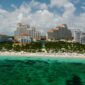Baha Mar resort towers rising above a beach and turquoise water on Cable Beach