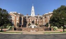 Delaware Legislative Hall in Dover, a red-brick building with white clock tower, under clear sky