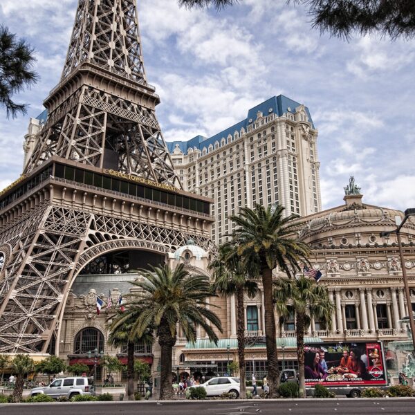 Paris Las Vegas with its Eiffel Tower replica and hotel tower behind palm trees