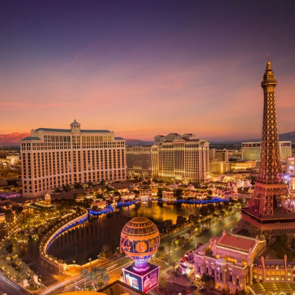 Las Vegas Strip at dusk with Bellagio fountains lake and Eiffel Tower replica