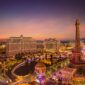Las Vegas Strip at dusk with Bellagio fountains lake and Eiffel Tower replica
