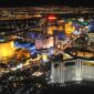 Aerial night view of the Las Vegas Strip with brightly lit casino resort towers