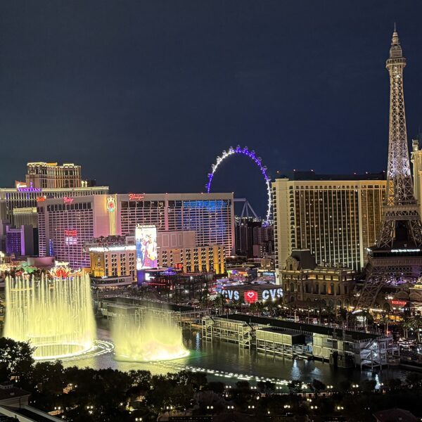 Las Vegas Strip at night with Bellagio fountains, Eiffel Tower replica and High Roller wheel