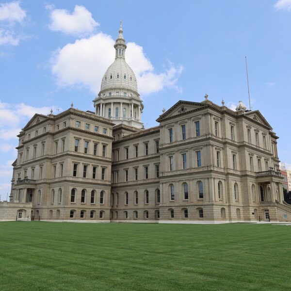 Michigan State Capitol in Lansing with its white dome above a wide green lawn