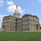 Michigan State Capitol in Lansing with its white dome above a wide green lawn
