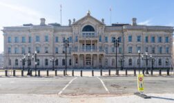 Front facade of the New Jersey State House in Trenton under a clear blue sky