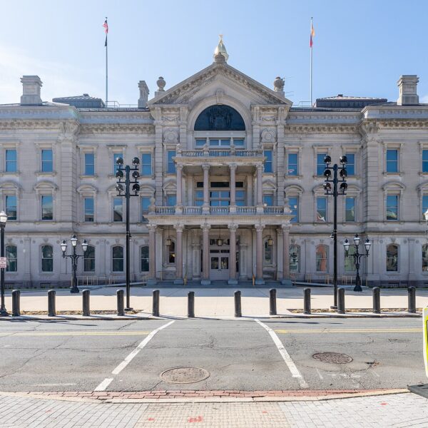 Front facade of the New Jersey State House in Trenton under a clear blue sky