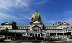 Pennsylvania State Capitol in Harrisburg with green dome under a blue sky