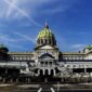 Pennsylvania State Capitol in Harrisburg with green dome under a blue sky